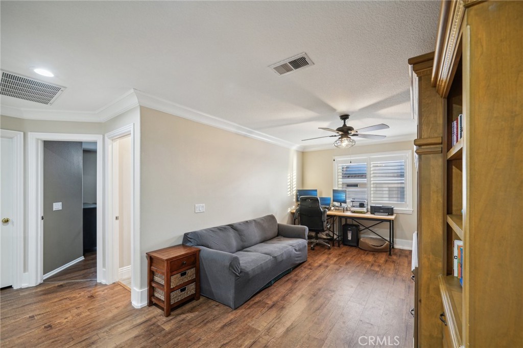 2575 Gilbert Avenue Corona, CA 92881 - Photo 30 of 58 a living room with furniture and a chandelier