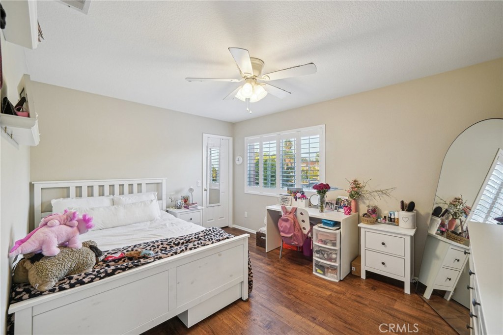 2575 Gilbert Avenue Corona, CA 92881 - Photo 35 of 58 a bedroom with a bed and wooden floor