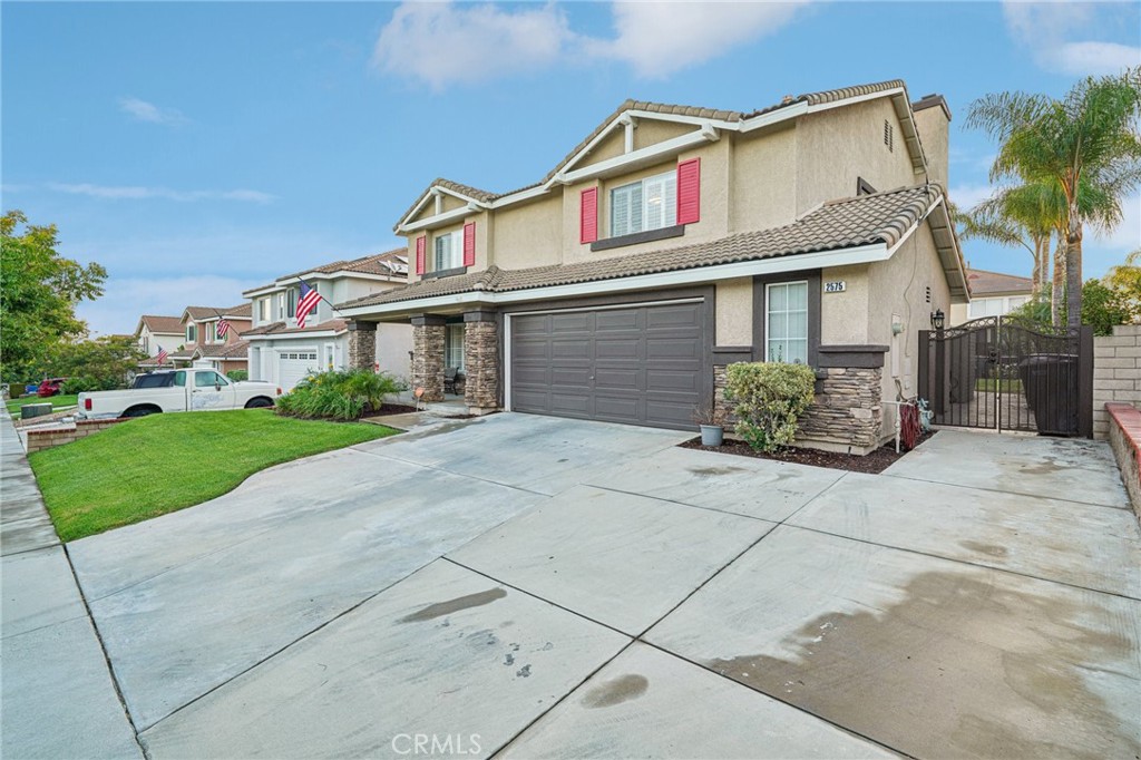 2575 Gilbert Avenue Corona, CA 92881 - Photo 4 of 58 a front view of a house with a yard and potted plants