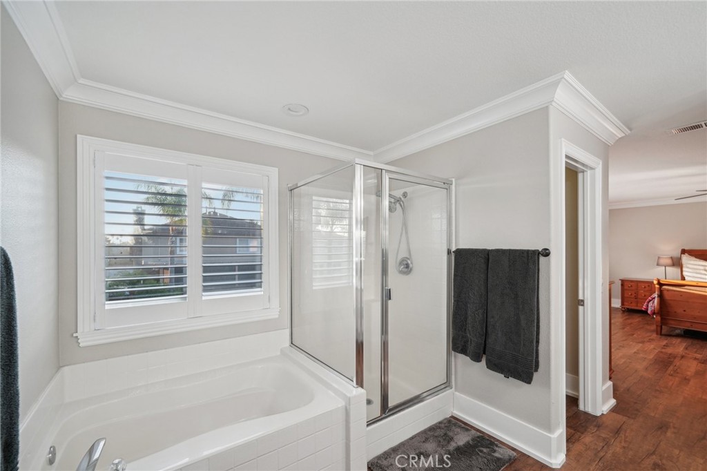 2575 Gilbert Avenue Corona, CA 92881 - Photo 41 of 58 a bathroom with a bathtub and a shower