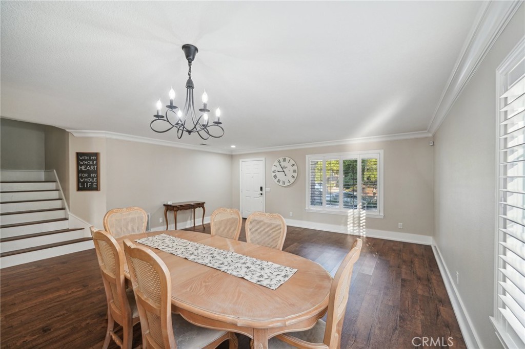 2575 Gilbert Avenue Corona, CA 92881 - Photo 8 of 58 a view of a dining room with furniture a chandelier and wooden floor