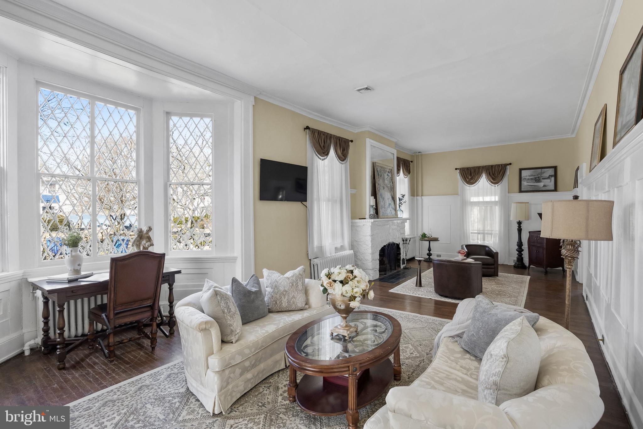 100 Main Street Riverton, NJ 08077 - Photo 13 of 44 a living room with furniture a fireplace and a large window