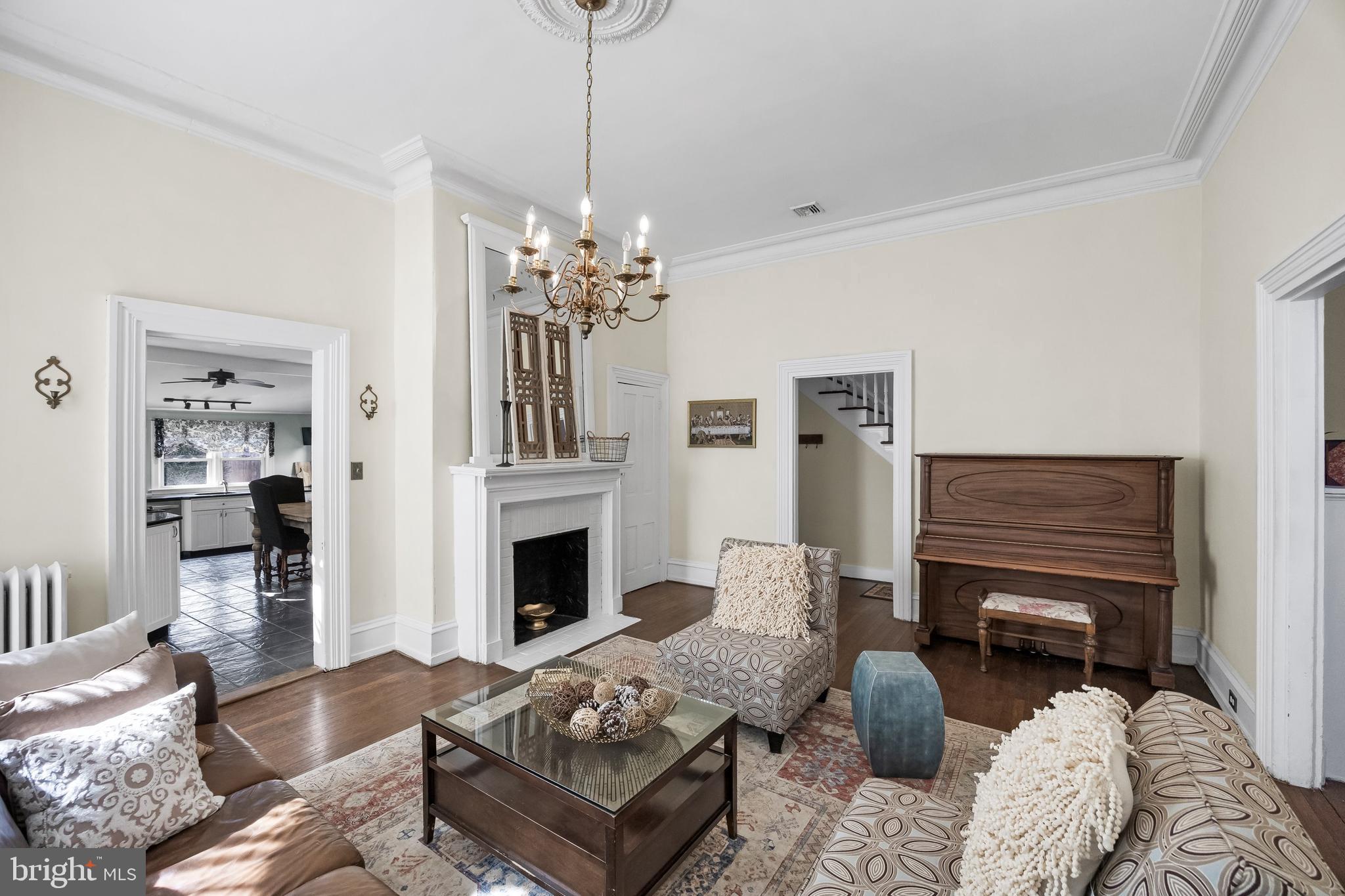 100 Main Street Riverton, NJ 08077 - Photo 17 of 44 a living room with furniture a fireplace and a chandelier