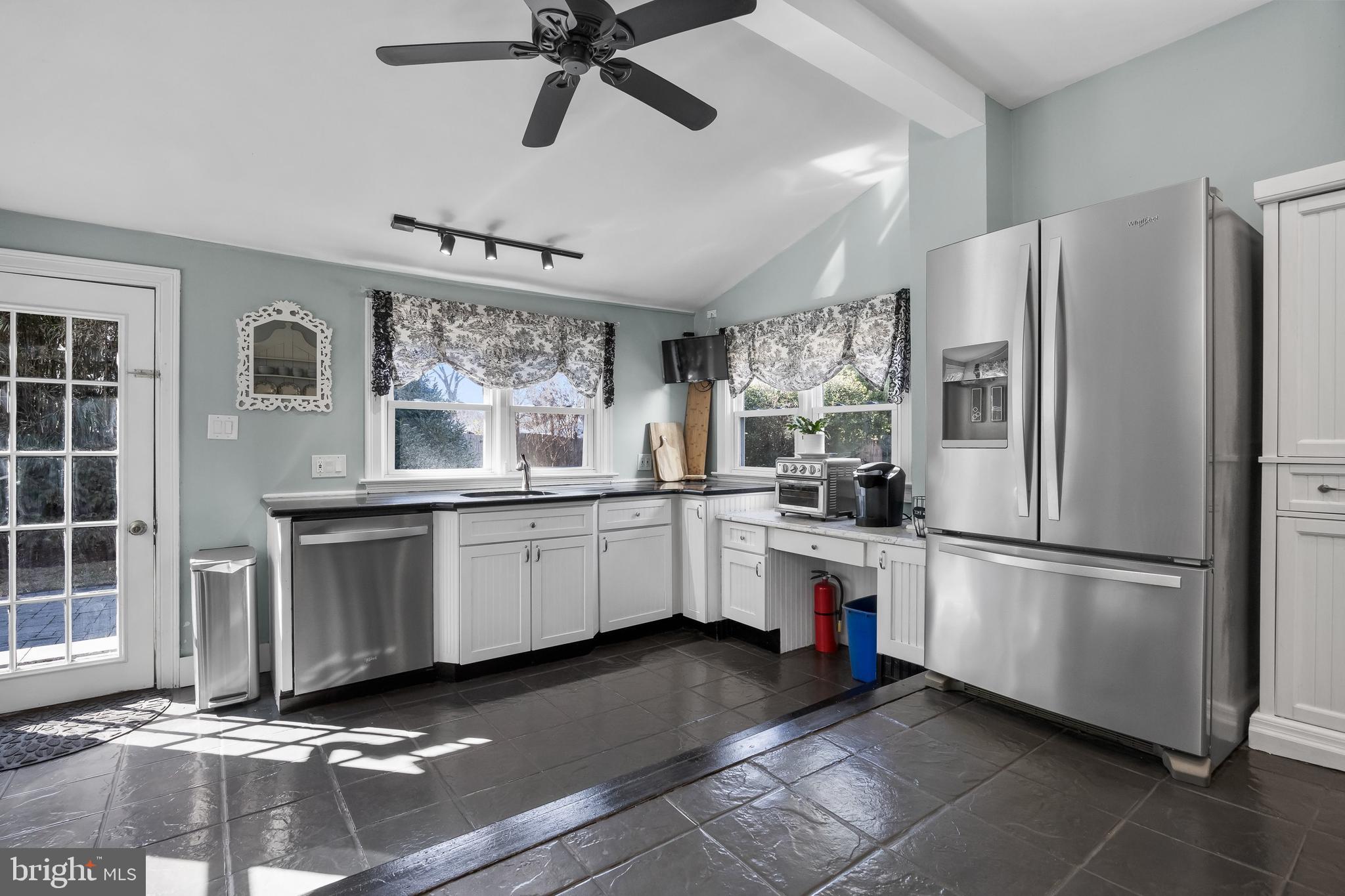 100 Main Street Riverton, NJ 08077 - Photo 21 of 44 a kitchen with granite countertop a refrigerator and white cabinets