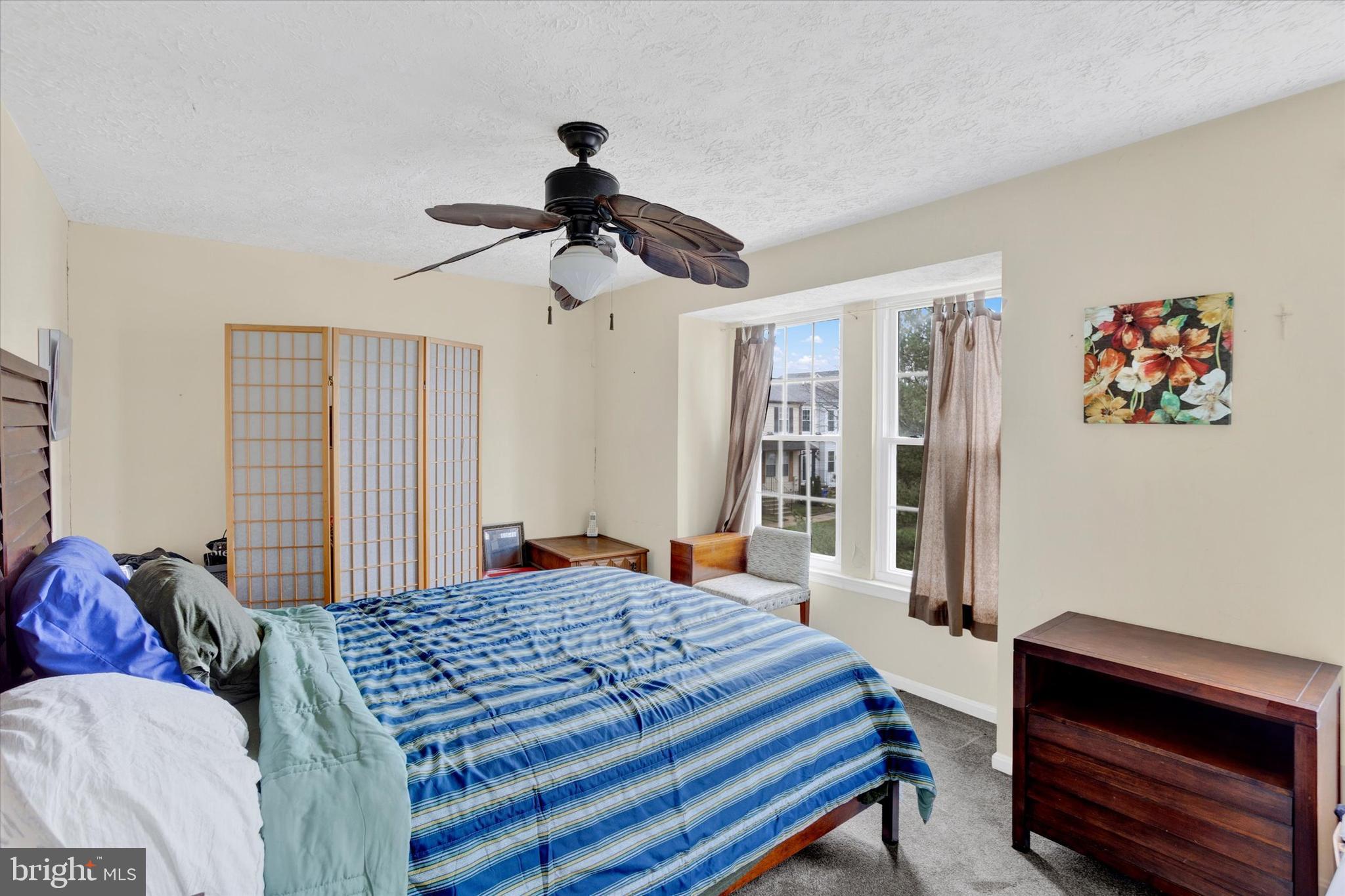 7278 Procopio Circle Columbia, MD 21046 - Photo 16 of 30 a bedroom with a bed and a chandelier