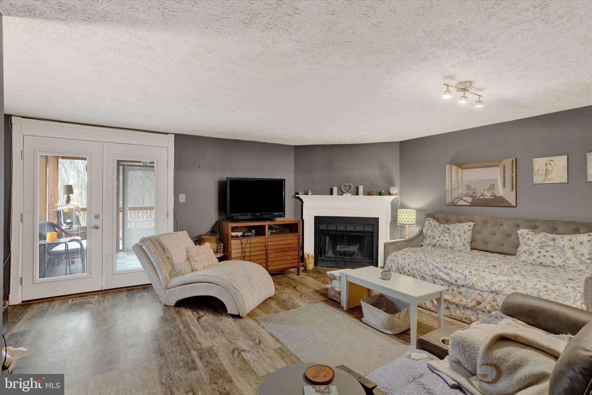 7278 Procopio Circle Columbia, MD 21046 - Photo 8 of 30 a living room with furniture a flat screen tv and a fireplace