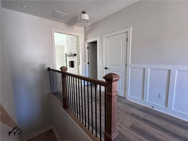 a view of a hallway with windows and stairs