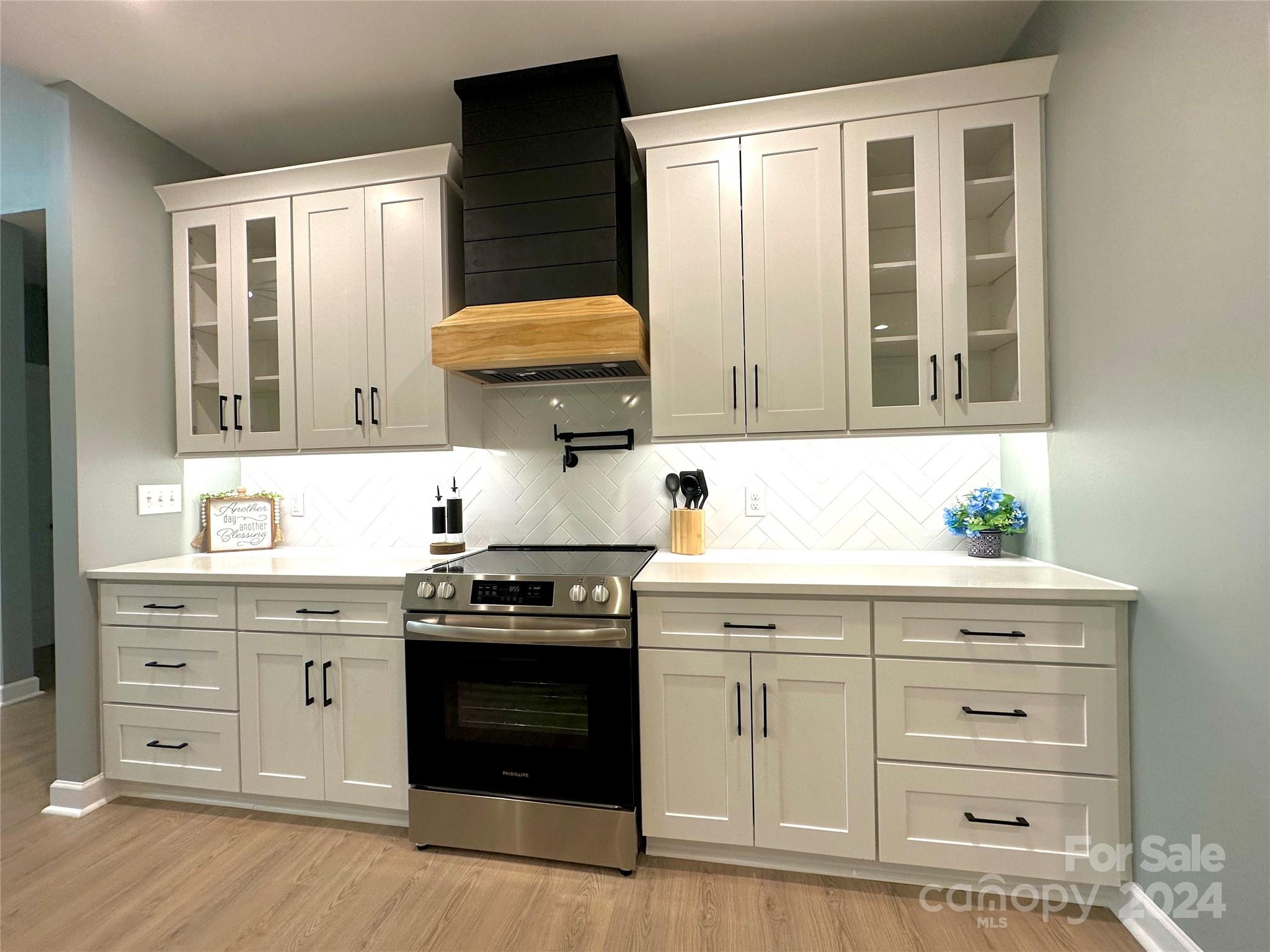 169 Harbor Point Drive Cherryville, NC 28021 - Photo 12 of 37 a kitchen with stainless steel appliances granite countertop a stove a sink and a microwave