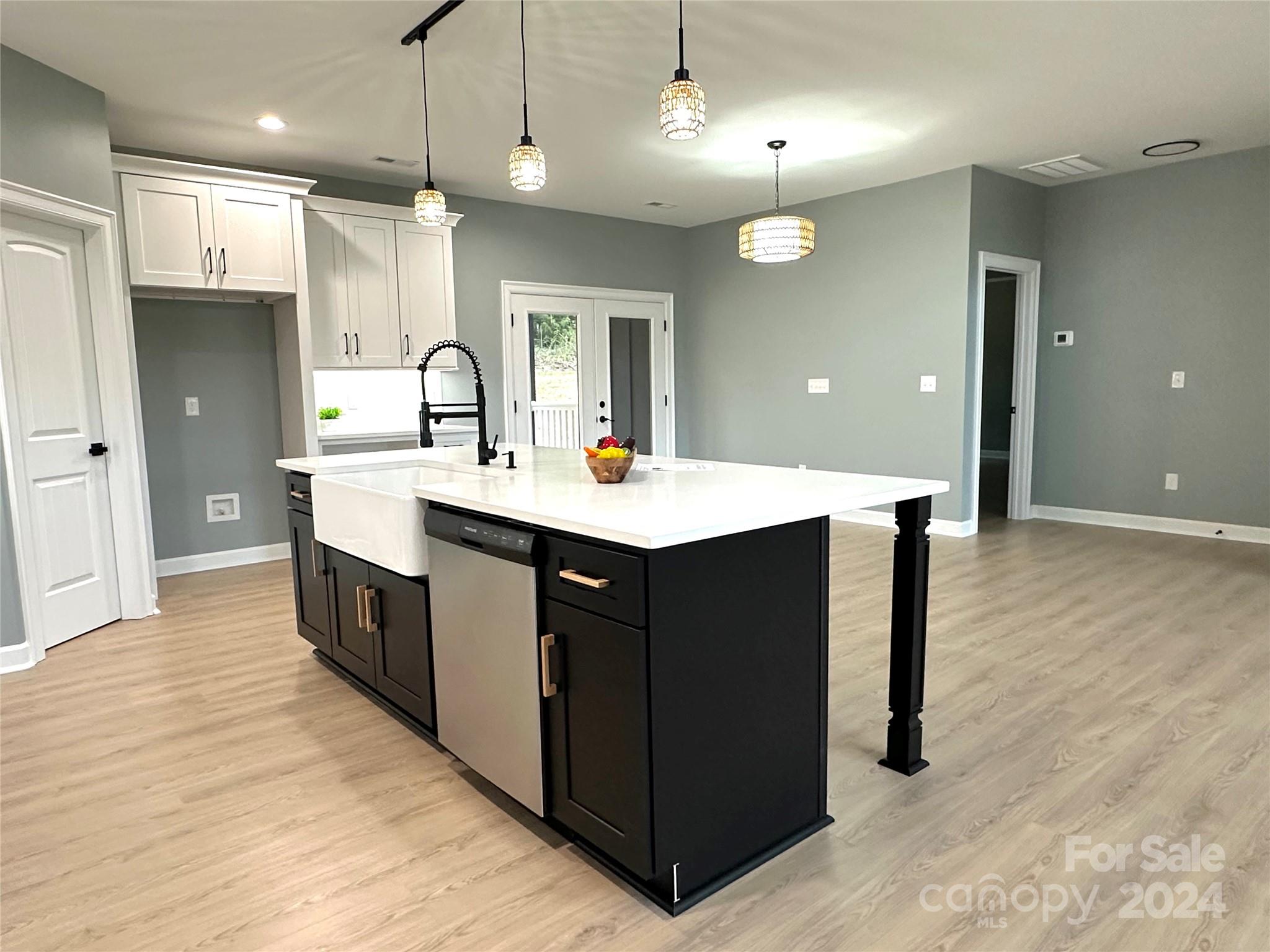 169 Harbor Point Drive Cherryville, NC 28021 - Photo 16 of 37 a kitchen with kitchen island a sink stainless steel appliances and cabinets