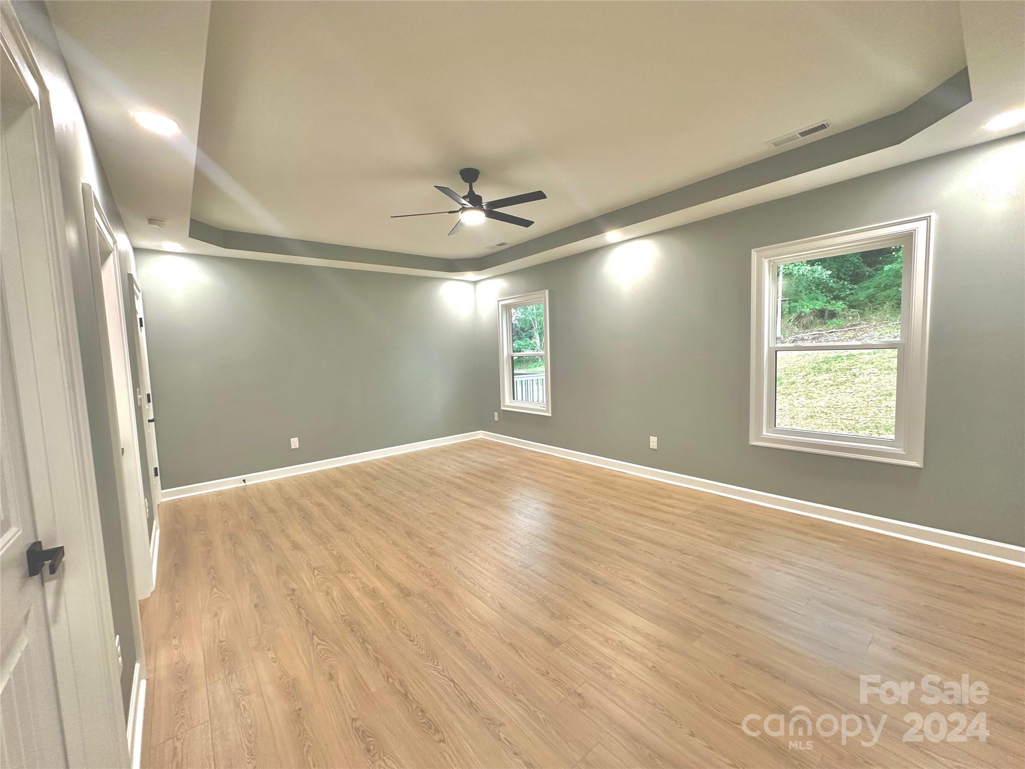 169 Harbor Point Drive Cherryville, NC 28021 - Photo 22 of 37 an empty room with windows and ceiling fan