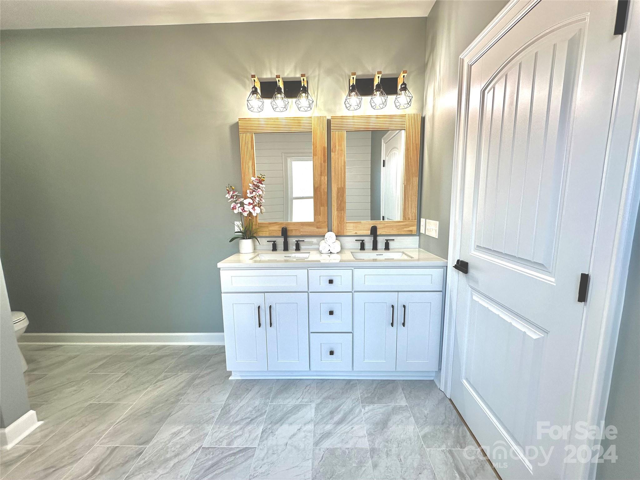 169 Harbor Point Drive Cherryville, NC 28021 - Photo 24 of 37 a bathroom with a double vanity sink and mirror