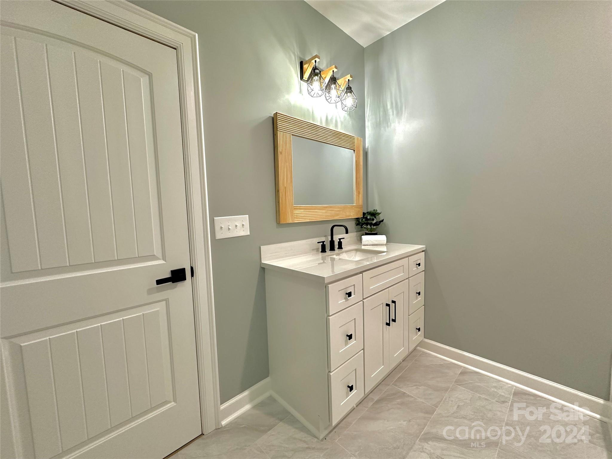 169 Harbor Point Drive Cherryville, NC 28021 - Photo 30 of 37 a bathroom with a double vanity sink and mirror