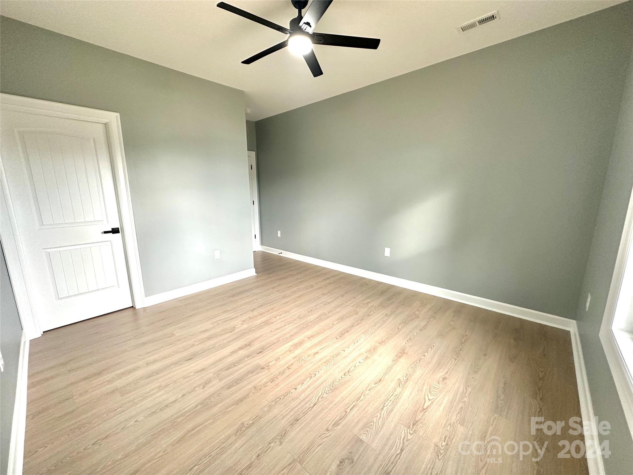 169 Harbor Point Drive Cherryville, NC 28021 - Photo 32 of 37 an empty room with wooden floor and windows