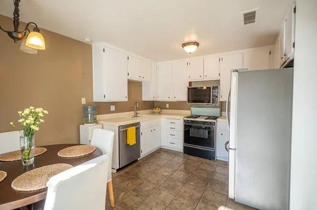 a kitchen with a sink stove and refrigerator