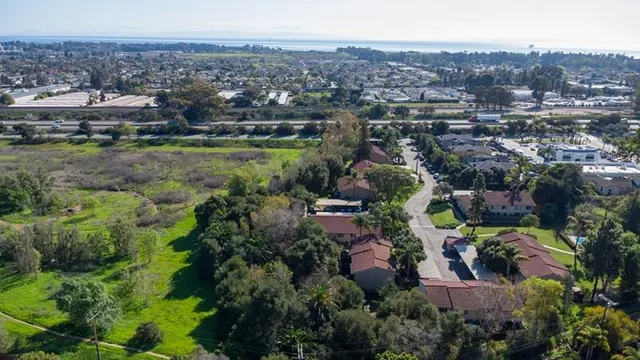 an aerial view of a houses with a lake view