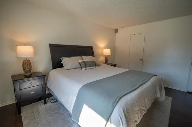 a bedroom with a bed and a lamp