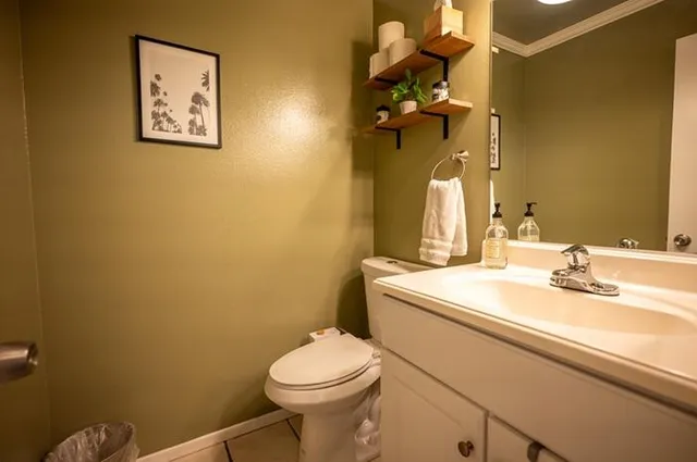 a bathroom with a toilet sink and mirror