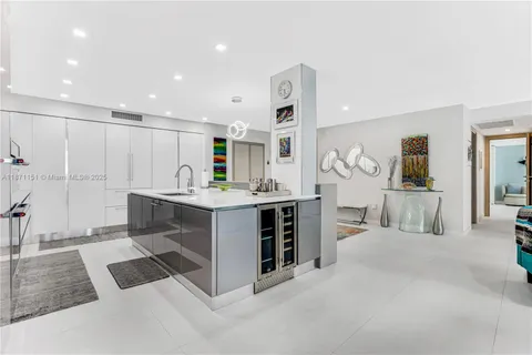 a living room with stainless steel appliances granite countertop sink a counter top space and furniture