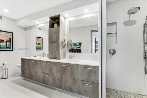a bathroom with a tub sink and mirror