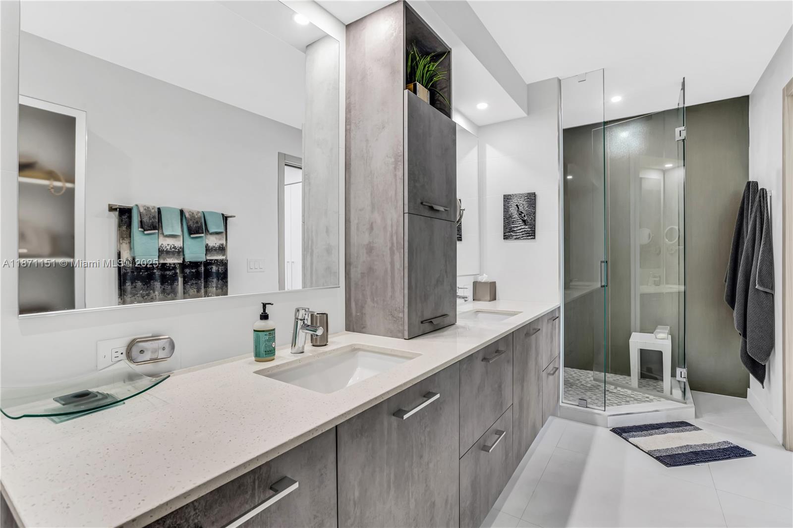 10155 Collins Avenue, Unit 606 Bal Harbour, FL 33154 - Photo 22 of 48 a bathroom with a sink and a mirror