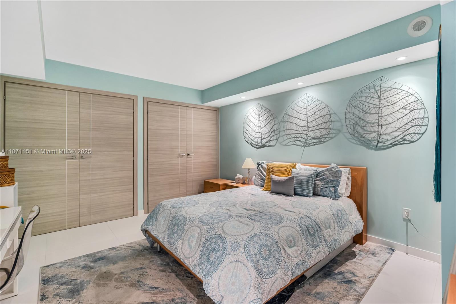 10155 Collins Avenue, Unit 606 Bal Harbour, FL 33154 - Photo 26 of 48 a bedroom with a large bed and a painting on the wall