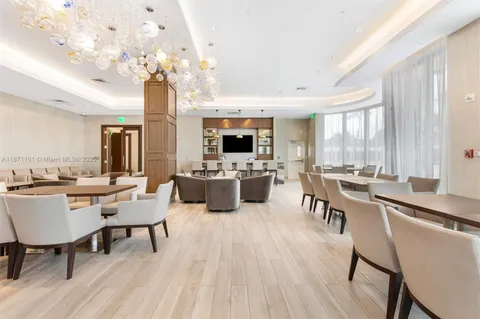 a living room with couches and a dining table with wooden floor