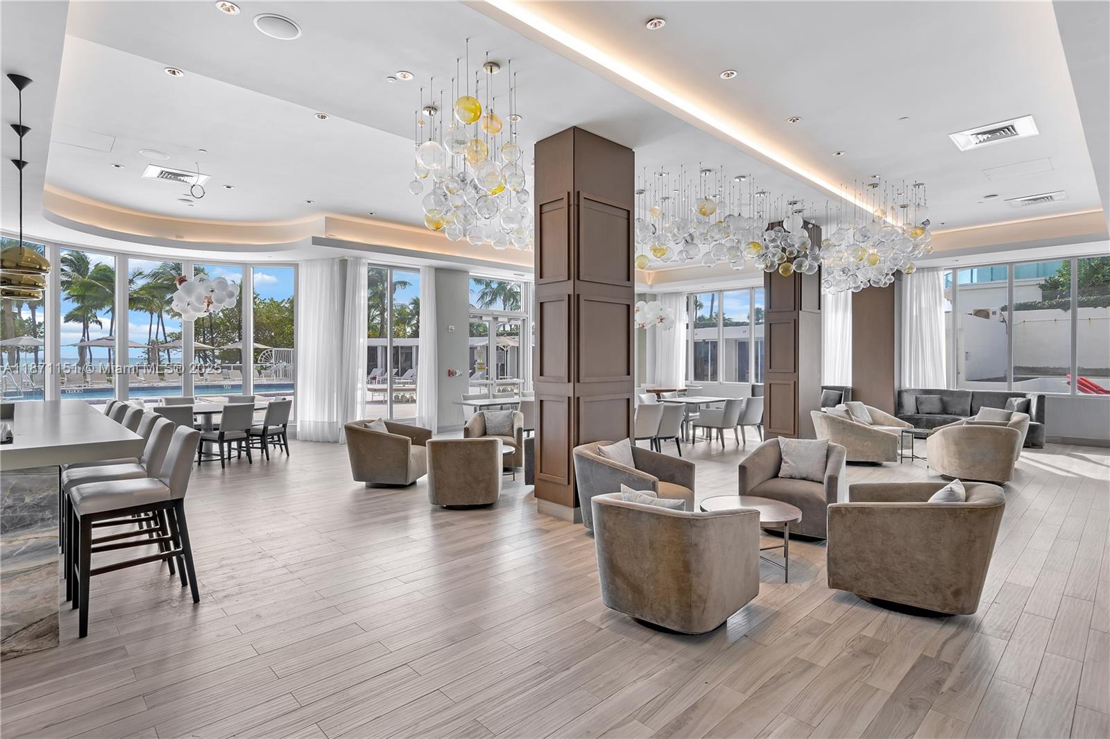 10155 Collins Avenue, Unit 606 Bal Harbour, FL 33154 - Photo 35 of 48 a living room with couches and a dining table with wooden floor