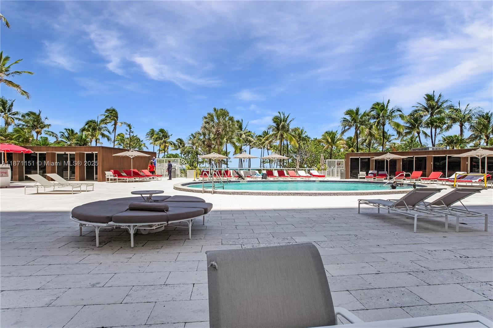 10155 Collins Avenue, Unit 606 Bal Harbour, FL 33154 - Photo 36 of 48 a view of a swimming pool and lounge chairs
