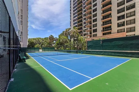 a balcony with chairs and a table