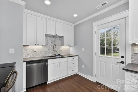 a view of cabinets a wooden floor and a window