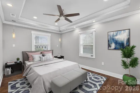 a bedroom with a large bed and a chandelier