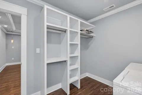 a view of walk in closet with empty racks