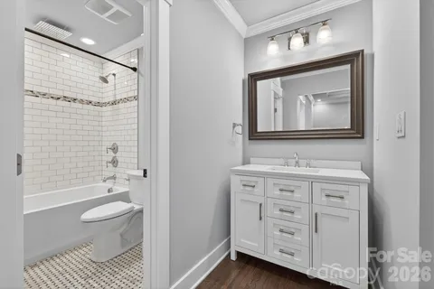 a bathroom with a toilet a sink and a large mirror