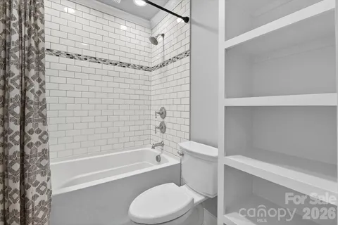 a bathroom with a toilet and a bathtub