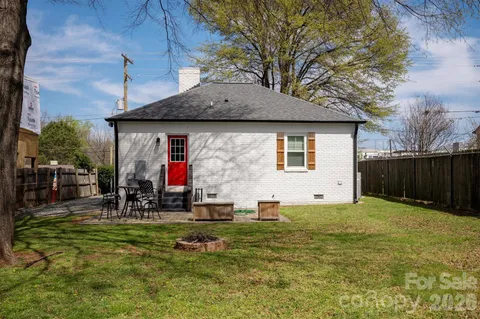 a view of a house with backyard and sitting area