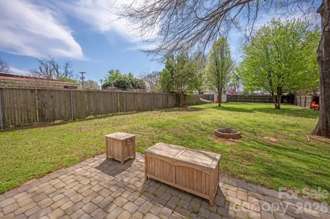 a view of a backyard with chair and plants