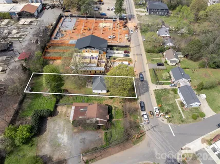 an aerial view of houses with street