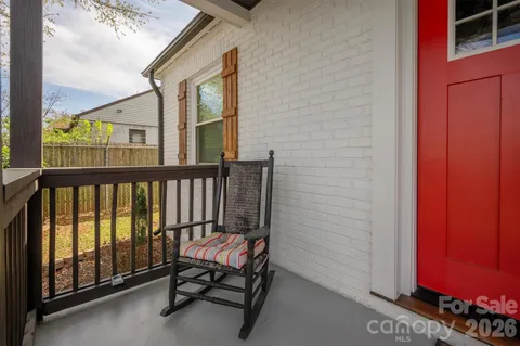 a view of a balcony with chair and door