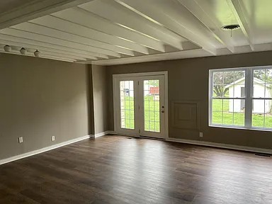 11495 Guthrie Road Guthrie, KY 42234 - Photo 2 of 7 an empty room with wooden floor and windows