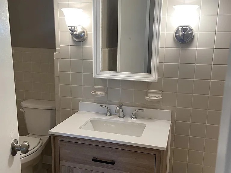 11495 Guthrie Road Guthrie, KY 42234 - Photo 6 of 7 a bathroom with a sink a toilet and a mirror