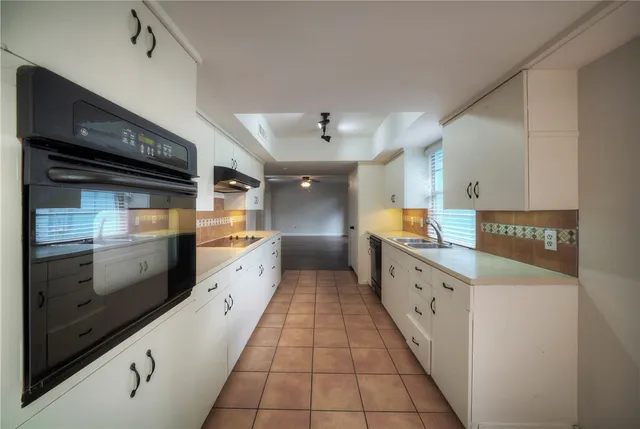 a large kitchen with granite countertop lots of counter top space