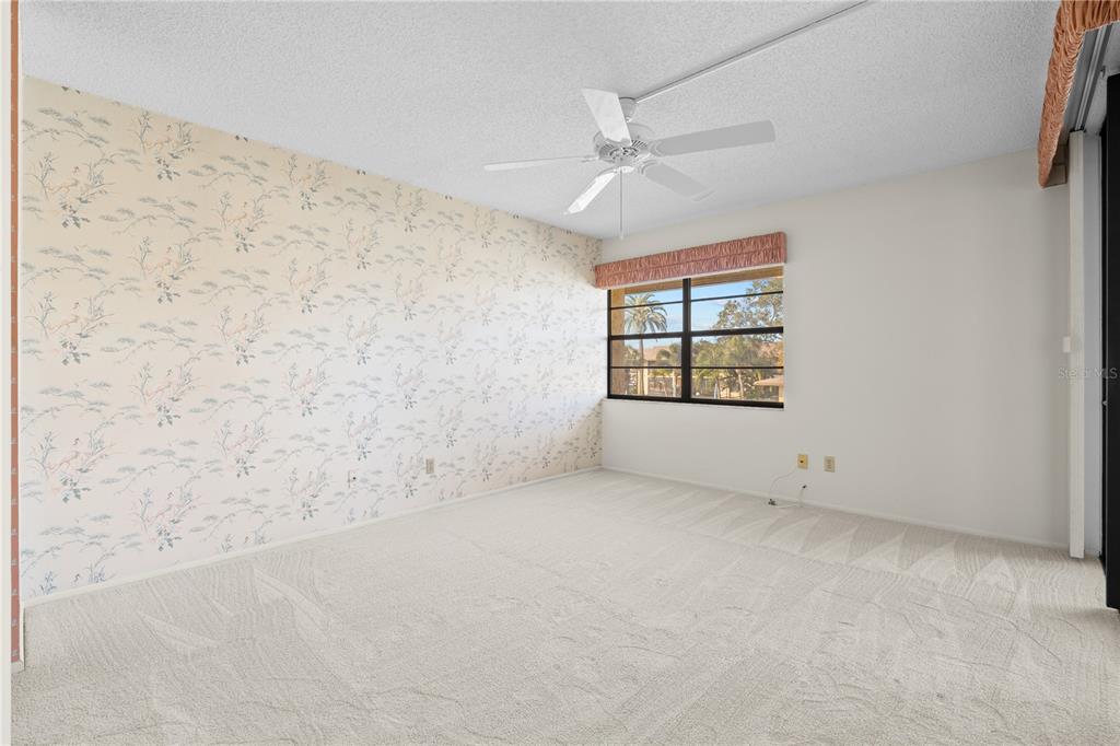12300 Vonn Road, Unit 1205 Largo, FL 33774 - Photo 14 of 32 an empty room with windows and fireplace