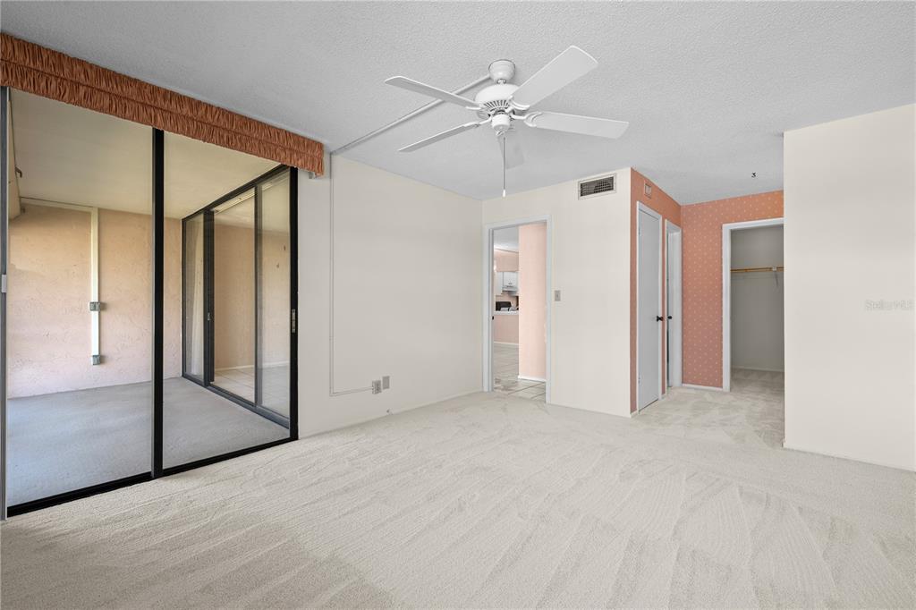 12300 Vonn Road, Unit 1205 Largo, FL 33774 - Photo 16 of 32 an empty room with closet and a chandelier fan