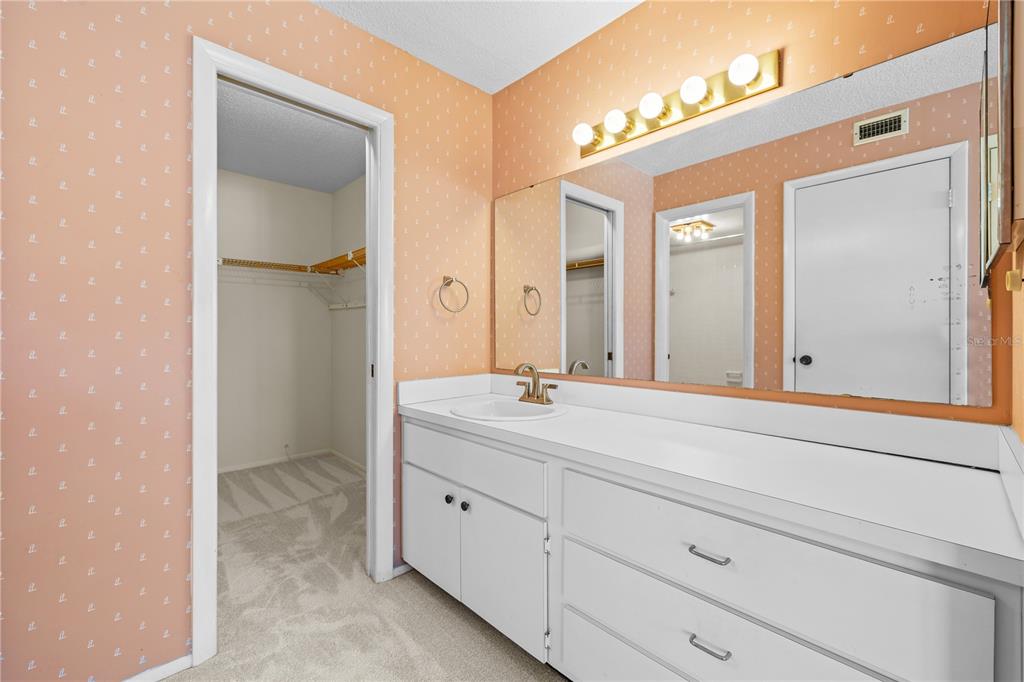 12300 Vonn Road, Unit 1205 Largo, FL 33774 - Photo 18 of 32 a bathroom with a double vanity sink and mirror
