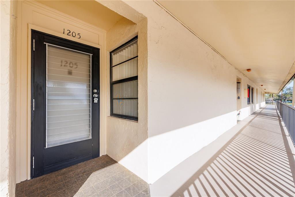 12300 Vonn Road, Unit 1205 Largo, FL 33774 - Photo 2 of 32 a hallway with a large window