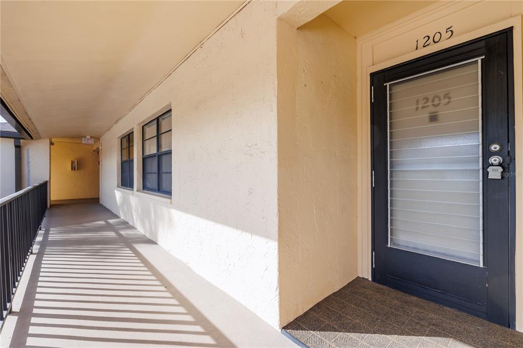 12300 Vonn Road, Unit 1205 Largo, FL 33774 - Photo 3 of 32 a view of a hallway with wooden floor and entryway
