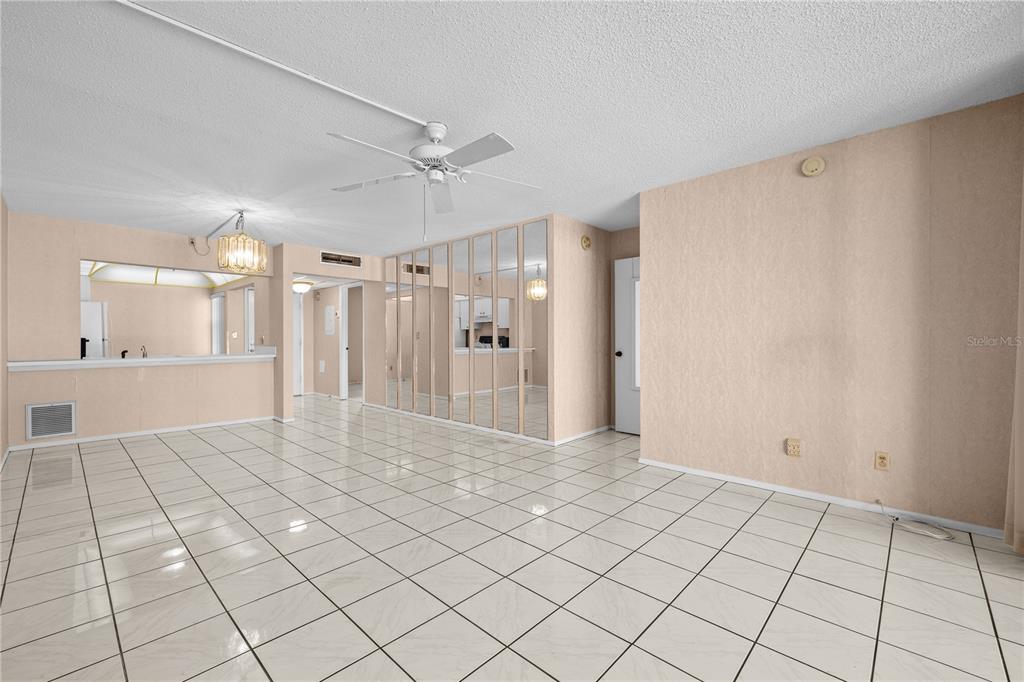 12300 Vonn Road, Unit 1205 Largo, FL 33774 - Photo 9 of 32 a view of a hallway with wooden floor and a chandelier fan