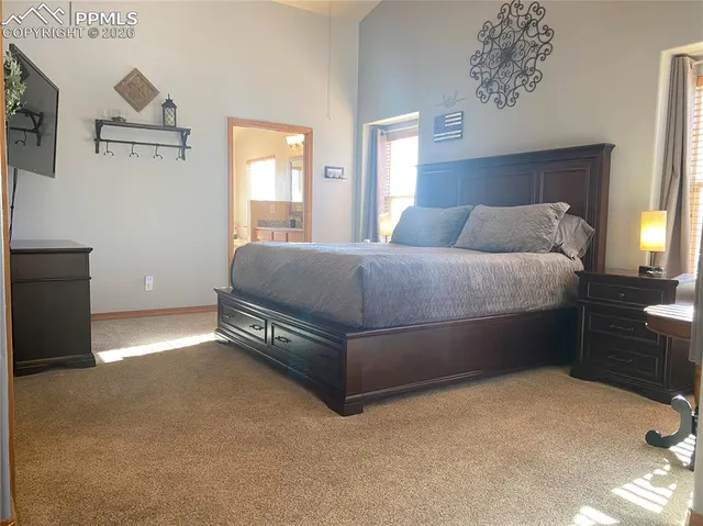 a spacious bedroom with a bed and window