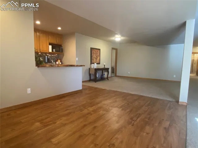 a view of kitchen with furniture and wooden floor