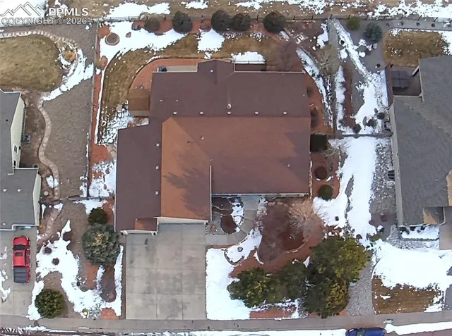 an aerial view of a house with a yard